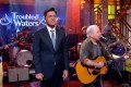 Stephen Colbert performs with Troubled Waters
