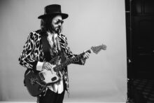 Mike Campbell performs live with guitar on stage during The Dirty Knobs tour.