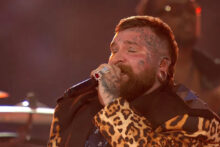 Teddy Swims performing at the 2025 NRL Grand Final in Sydney wearing a leopard print coat.