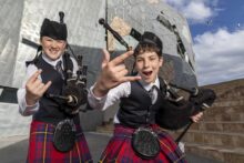 Bagpipers at Fed Square preparing for The Great Melbourne Bagpipe Bash celebrating AC/DC