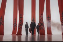 HOKKA band promotional image with red curtain backdrop