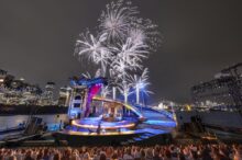 The Phantom Of The Opera Stage Over Sydney Harbour, with the Sydney Opera House in the background.