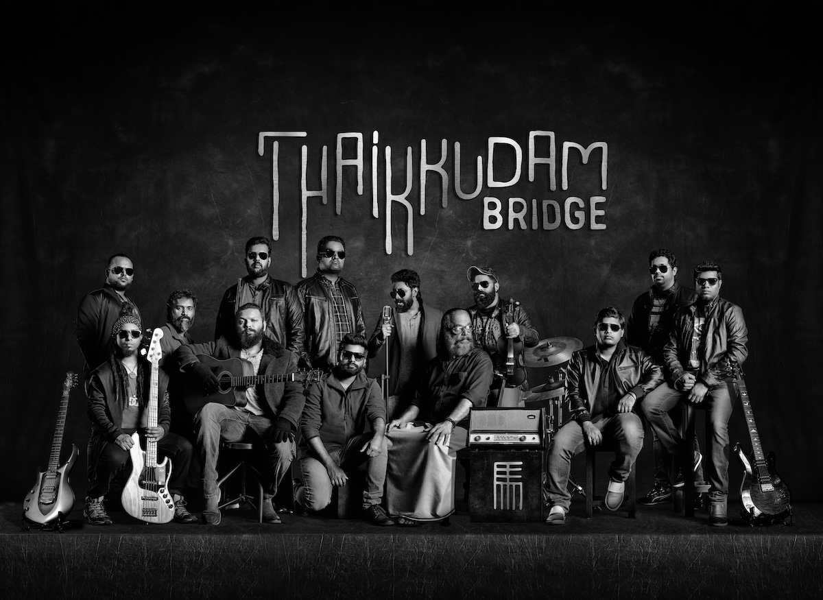 Thaikkudam Bridge performing live with full ensemble on stage