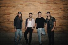 Parmalee band photo celebrating number one country radio hit Cowgirl