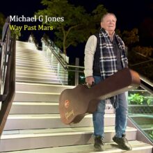 Michael G. Jones performing with guitar