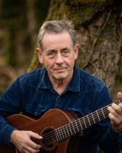 Luka Bloom performing live with acoustic guitar