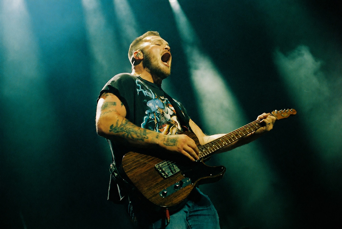 Zach Bryan performing live on stage